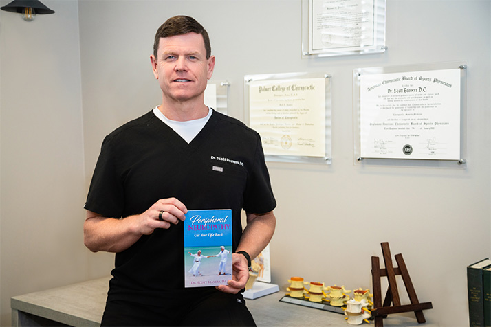 Chiropractor Rocklin CA Scott Beavers With His Book